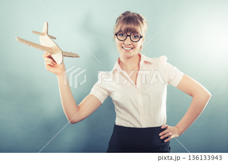 woman thinking about vacation holds airplane woman thinking about vacation holds airplane 136133943