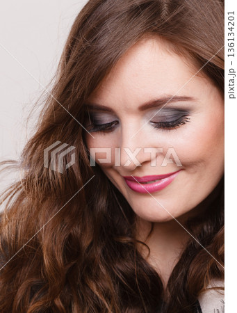 Portrait of happy attractive woman wearing grey top 136134201