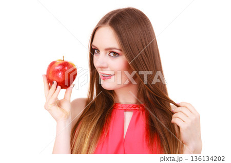 Woman charming girl colorful makeup holds apple fruit Woman charming girl colorful makeup holds apple fruit 136134202