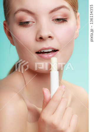 woman applying balsam for lips woman applying balsam for lips 136134355