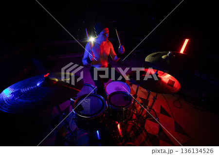 Drummer performing live on stage during concert Drummer performing live on stage during concert 136134526