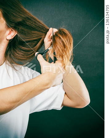 Male hands cutting long hair 136134705