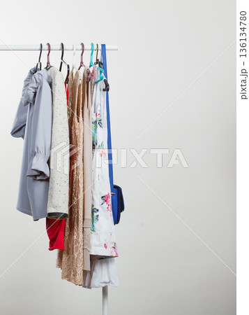 Clothes on hangers in closet Clothes on hangers in closet 136134780