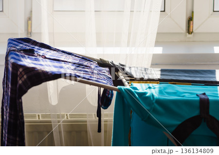 Colorful clothes on drying rack. Colorful clothes on drying rack. 136134809