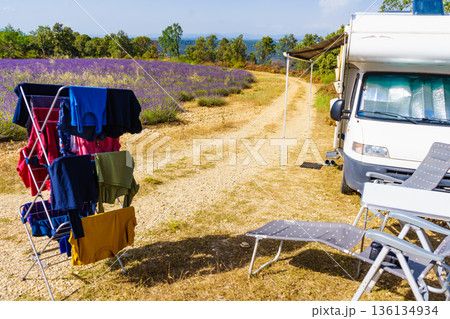 Clothes hanging to dry outdoors by camping car. Caravan vacation in France Clothes hanging to dry outdoors by camping car. Caravan vacation in France 136134934