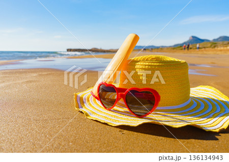 Sun protection gear on sand beach 136134943