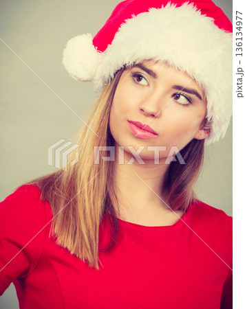 Thinking woman wearing Santa Claus helper costume Thinking woman wearing Santa Claus helper costume 136134977