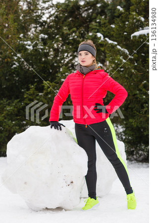 Woman wearing sportswear exercising during winter 136134980