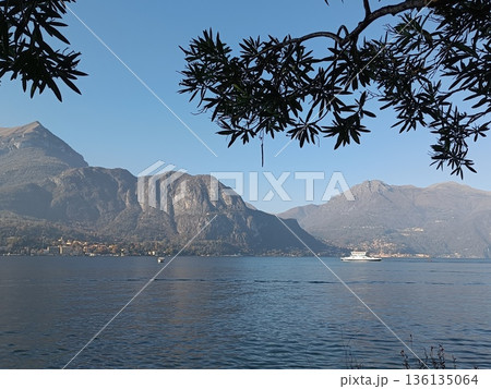 TREMEZZO, ITALY - Lake Como on a cloudy spring evening. TREMEZZO, ITALY - Lake Como on a cloudy spring evening. 136135064