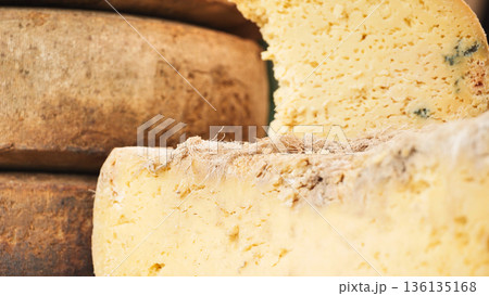 Aged cheese wheels showing rustic artisan dairy product 136135168