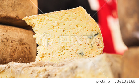 Artisan blue cheese wheel slice on display Artisan blue cheese wheel slice on display 136135169