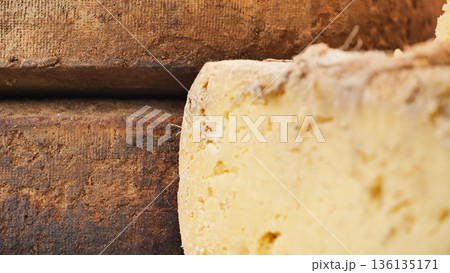 Artisan aged cheese wheel with rustic rind, traditional dairy food product 136135171