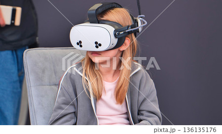 Child exploring virtual reality world with VR headset Child exploring virtual reality world with VR headset 136135176
