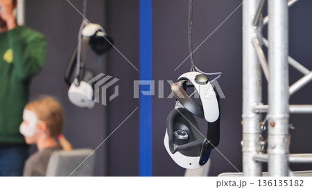 Virtual reality headsets hanging at gaming event 136135182