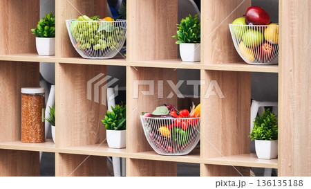 Wooden shelf displaying fresh fruit and decorative plants Wooden shelf displaying fresh fruit and decorative plants 136135188