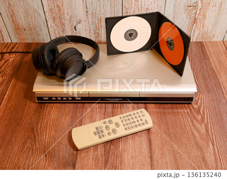 player with headphones and vertically standing discs player with headphones and vertically standing discs 136135240