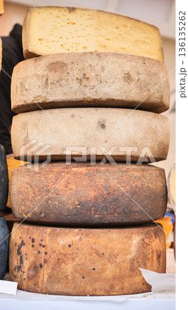 Artisan cheese wheels stacking, showing rustic rinds and dairy food Artisan cheese wheels stacking, showing rustic rinds and dairy food 136135262