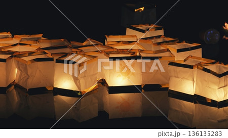 Floating paper lanterns illuminating river at night festival 136135283