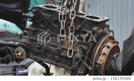 Mechanic repairing car engine at auto service station Mechanic repairing car engine at auto service station 136135308