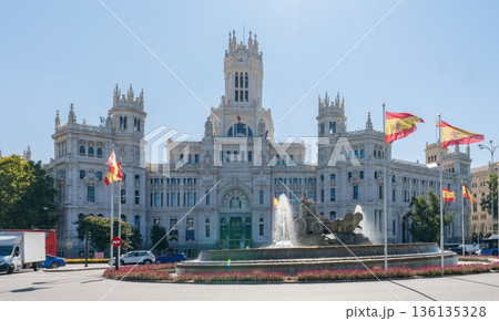 Palacio de Cibeles and fountain with Spanish flags in Madrid, Spain 136135328