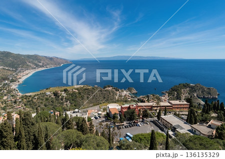 Panoramic view of Taormina coastline and Ionian Sea with Isola Bella, Sicily, Italy 136135329