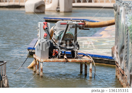 Portable drainage pump with electric motor on dock 136135331