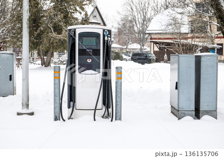 Electric Vehicle Charging Station On Snow Covered Residential Street 136135706