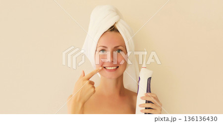 happy smiling young woman points to her clean white teeth happy smiling young woman points to her clean white teeth 136136430