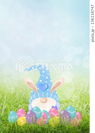 Cute easter gnome with bunny ears sitting in grass 136138747