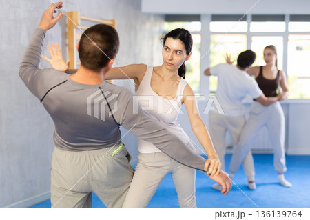 Woman hits man attacker on head during self-defense training session led by trainer Woman hits man attacker on head during self-defense training session led by trainer 136139764