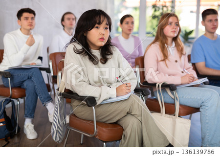 Interested Chinese girl student attending educational course 136139786