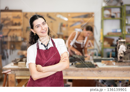 Girl is busy in carpentry workshop 136139901
