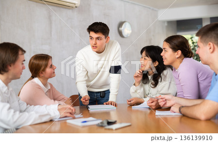 Young male professor explaining subject to group of students Young male professor explaining subject to group of students 136139910