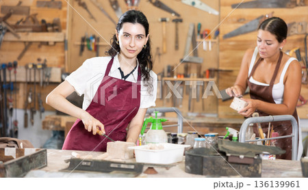 Girl working with wood in carpentry workshop Girl working with wood in carpentry workshop 136139961