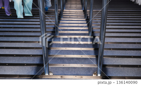 Modern staircase with green lights and silhouetted parent and child climbing Modern staircase with green lights and silhouetted parent and child climbing 136140090