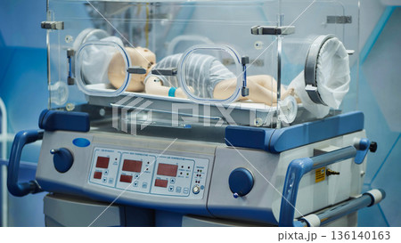 Infant incubator with mannequin baby in neonatal intensive care unit Infant incubator with mannequin baby in neonatal intensive care unit 136140163