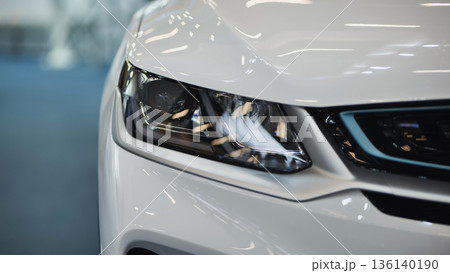 White car headlight close up showing modern vehicle design and technology 136140190