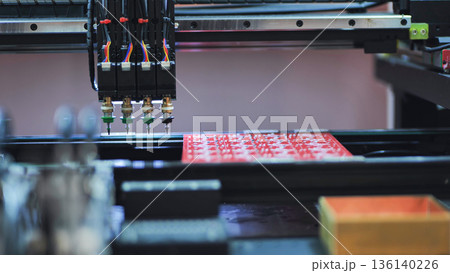 Pick and place robot machine assembling electronic circuit boards in factory Pick and place robot machine assembling electronic circuit boards in factory 136140226