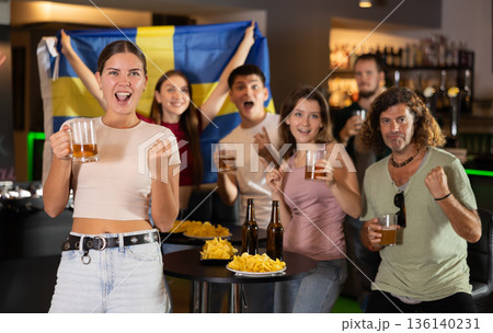 Group of fans in bar with Swedish flag Group of fans in bar with Swedish flag 136140231