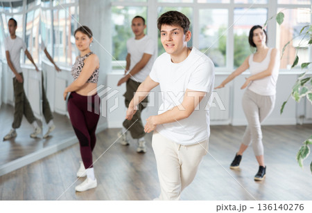 Guy enjoys active dancing, learns new movements, moves synchronously with participants of lesson Guy enjoys active dancing, learns new movements, moves synchronously with participants of lesson 136140276