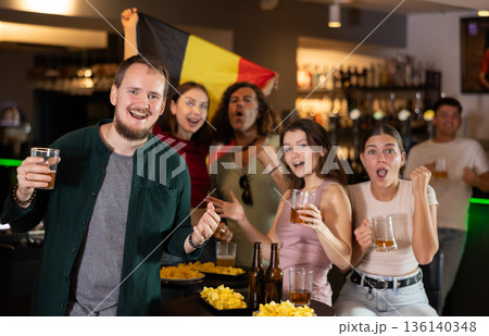 Group of fans in bar with Belgian flag 136140348