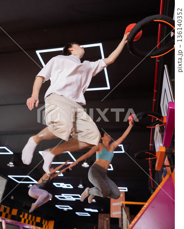 Young guy playing ball in trampoline center Young guy playing ball in trampoline center 136140352