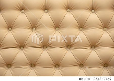 Beige leather upholstery with tufting pattern and decorative buttons background Beige leather upholstery with tufting pattern and decorative buttons background 136140425