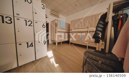 Hostel dormitory with bunk beds and lockers for budget travel accommodation 136140509