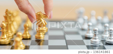 hand moving gold Chess knight figure and Checkmate opponent during chessboard competition. Strategy, Success, management, business planning, win, disruption, Trade war and leadership concept hand moving gold Chess knight figure and Checkmate opponent during chessboard competition. Strategy, Success, management, business planning, win, disruption, Trade war and leadership concept 136141861