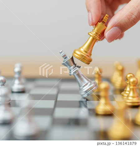 hand moving gold Chess King figure and Checkmate opponent during chessboard competition. Strategy, Success, management, business planning, win, disruption, Trade war and leadership concept hand moving gold Chess King figure and Checkmate opponent during chessboard competition. Strategy, Success, management, business planning, win, disruption, Trade war and leadership concept 136141879