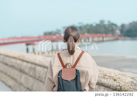 Woman tourist sightseeing Fukuura jima bridge or the bridge of romantic encounters for Fukuura Island at Matsushima Bay in Matsushima, Miyagi Prefecture, Tohoku, Japan. Landmark and famous Vacation 136142292