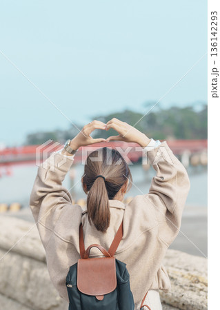 Woman tourist sightseeing Fukuura jima bridge or the bridge of romantic encounters for Fukuura Island at Matsushima Bay in Matsushima, Miyagi Prefecture, Tohoku, Japan. Landmark and famous Vacation 136142293