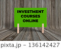 Concept words Investment Courses Online, Green Texture Rectangle Card Held By Clothespin Wooden Texture Background, Business and Investment Courses Online Theme 136142427