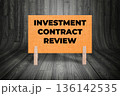 Concept words Investment Contract Review, Light Orange Grunge Texture Rectangle Card Held By Clothespin Wooden Texture Background, Business and Investment Contract Review Theme 136142535